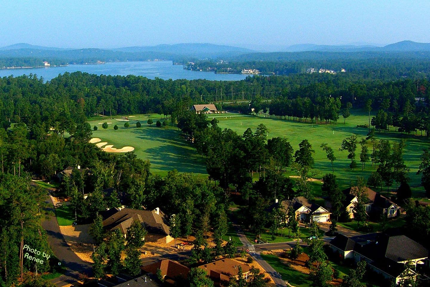 Aerial view of a Hot Springs Village golf course, lake, and clubhouse in the Arkansas Ouachitas