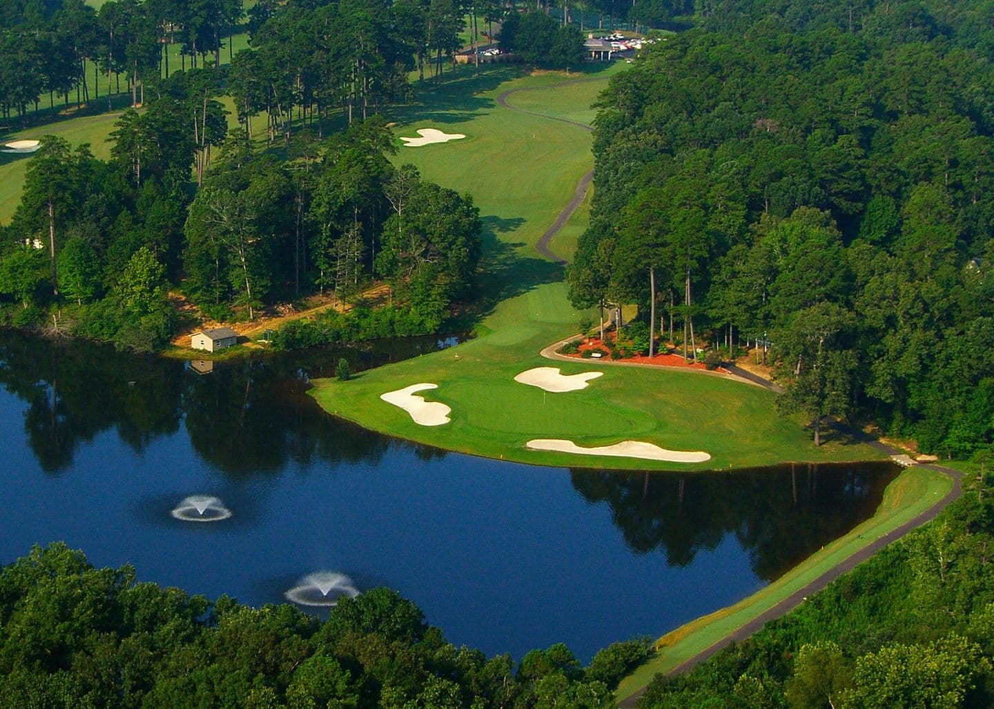 Island-green golf hole framed by water at Hot Springs Village, Arkansas